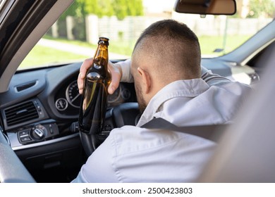 Man drinking alcohol while driving a car. Don't drink and drive concept.