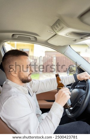 Man drinking alcohol while driving a car. Don't drink and drive concept.