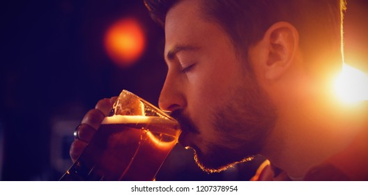 Man Drinking Beer In Bar