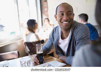 Man drinking beer at bistro table - Powered by Shutterstock