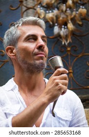 Man Drinking Beer  And Medieval Mead Horn In Hand. Toast Concept