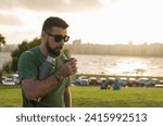 Man drinking chimarrao, mate (an infusion of yerba mate with hot water) at sunset in uruguay