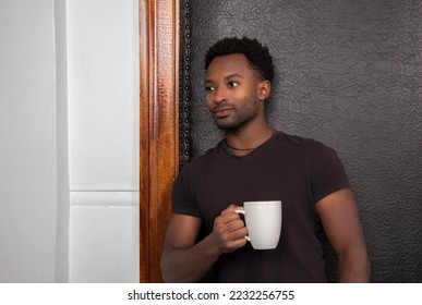 man drinking coffee leaning on door frame standing and dreaming relaxed owner - Powered by Shutterstock