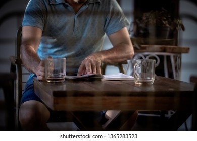 
A man drinking coffee and studying. - Shutterstock ID 1365283523