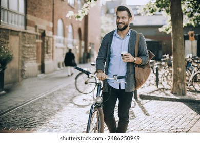 Man Drinking Coffee and Walking with Bicycle in City - Powered by Shutterstock