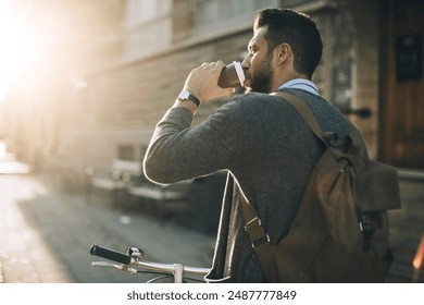 Man Drinking Coffee and Walking with Bicycle in City - Powered by Shutterstock