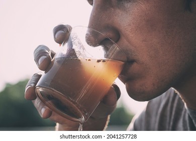 Man Is Drinking Dirty Water From The Glass Cup
