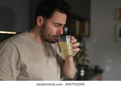 Man drinking electrolytes in the kitchen
