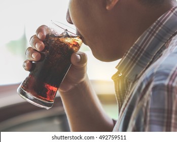 Man Drinking A Glass Of Soda With Ice