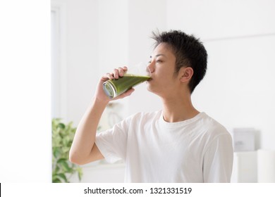 A Man Drinking Green Juice For Breakfast