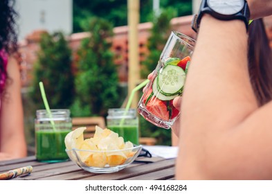 Man drinking infused fruit water cocktails outdoors - Powered by Shutterstock