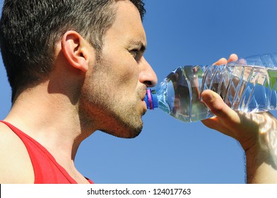 Man Is Drinking Water Against Blue Sky