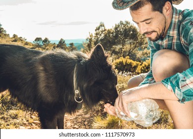 Man Drinking Water For His Dog .Guy Giving His Dog Water