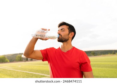 man drinking water outdoors after sports - Powered by Shutterstock