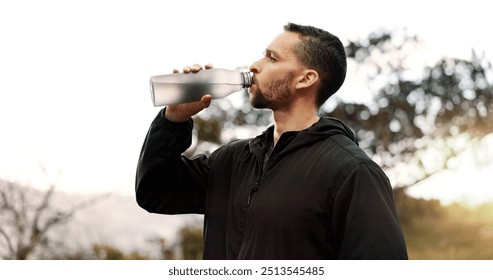 Man, drinking water or profile in nature for fitness, hydration or electrolytes for energy. Athlete, break or liquid in bottle for refreshment, healthy body or rest from running on mountain in Brazil - Powered by Shutterstock