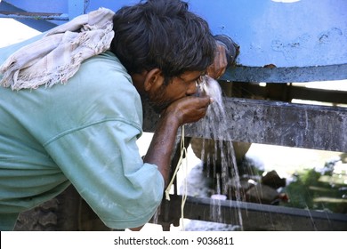 Man Drinking Water From Tank, South India