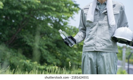 A Man Drinking Water. Workers To Prevent Heat Stroke.