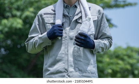 A Man Drinking Water. Workers To Prevent Heat Stroke.