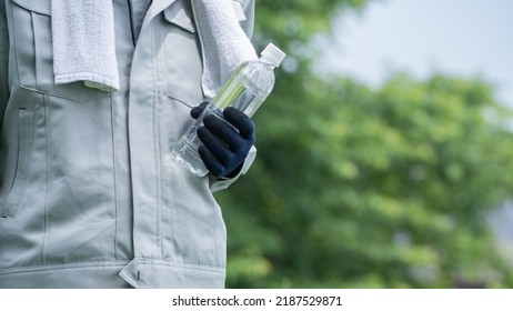 A Man Drinking Water. Workers To Prevent Heat Stroke.