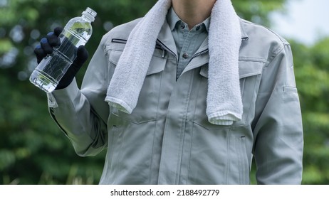 A Man Drinking Water. Workers To Prevent Heat Stroke.