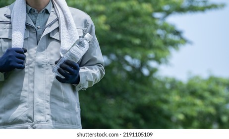 A Man Drinking Water. Workers To Prevent Heat Stroke.