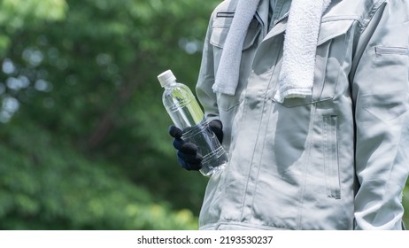 A Man Drinking Water. Workers To Prevent Heat Stroke.