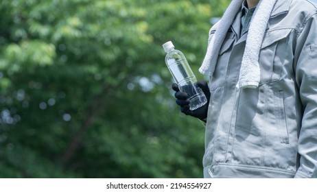 A Man Drinking Water. Workers To Prevent Heat Stroke.