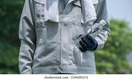 A Man Drinking Water. Workers To Prevent Heat Stroke.