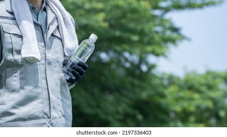 A Man Drinking Water. Workers To Prevent Heat Stroke.