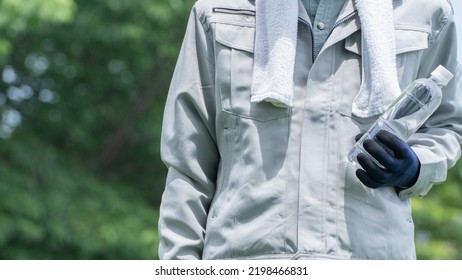 A Man Drinking Water. Workers To Prevent Heat Stroke.