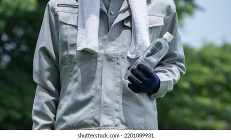 A Man Drinking Water. Workers To Prevent Heat Stroke.