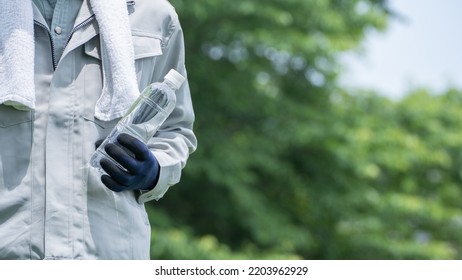 A Man Drinking Water. Workers To Prevent Heat Stroke.