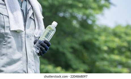 A Man Drinking Water. Workers To Prevent Heat Stroke.