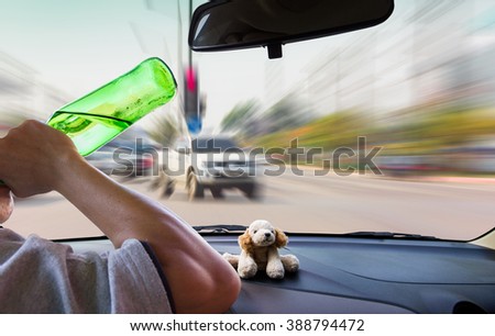 man drinking while driving .