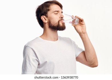  A man drinks water from a glass                              
