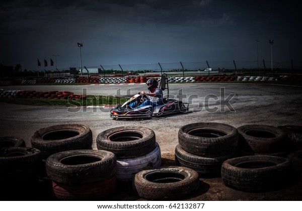 man drive go\
kart on track entering the\
curve