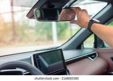 man driver adjusting rear view mirror a car. Journey, trip and safety Transportation concepts