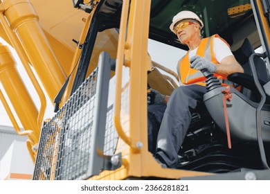 Man driver builder operate crane or excavator at construction site with sun light. Portrait Industry worker. - Powered by Shutterstock