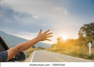 Man driver feeling the wind through his hands while driving in the country side.(freedom concept)copy space.