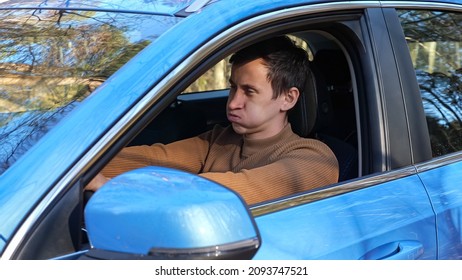 Man driver feels stressed and depressed from new car breakdown sitting in auto cabin parked on side of road near autumn forest close view - Powered by Shutterstock