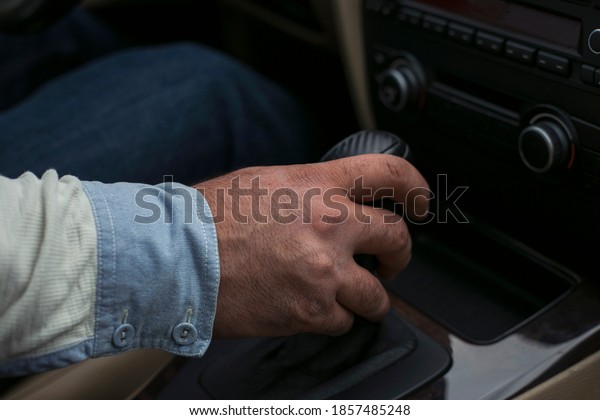  man driver hand\
shifting the gear stick