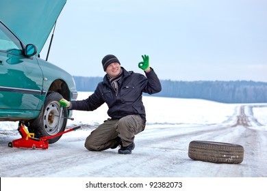 Man Driver Having Trouble At The Road, Changing Wheel, Repairing Car And Giving Okay Sign Hand Gesture