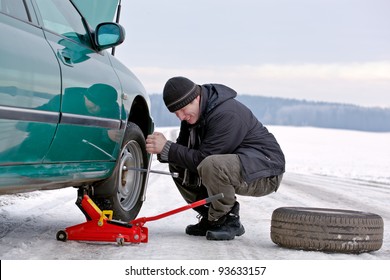 Man Driver Having Trouble At Road Changing Wheel, Repairing Car, Unscrewing Bolts