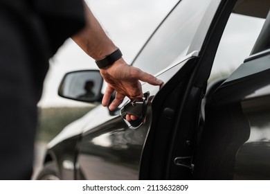 Man Driver Opens The Car Door. Men's Hand Opening By The Handle Of The Car Door. Guy Rented A Car