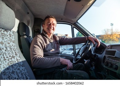 A Man Driver Is Sitting In The Cab Of A Modern Truck.