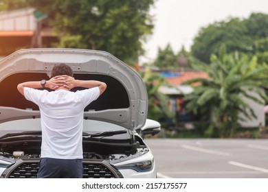 Man Driver Standing Near A Problem Car. Breakdown Or Broken Car On Road. Vehicle Insurance, Maintenance And Service Concept