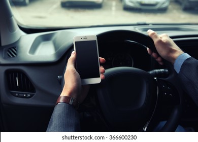 Man Driver Using Smart Phone In Car