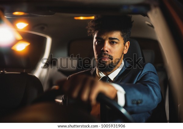 A man drives a car after a\
job.
