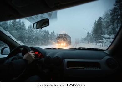 Man Drives A Car During Winter Speedway In A Snow Storm In The Twilight When Snow With Rain Is Flying. Concept Of Driving In The Dangerous Conditions With Bad Visibility On The Winter.