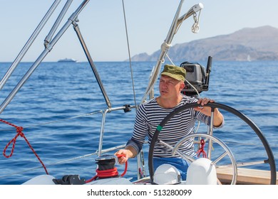 Man Drives Sailing Yacht At The Sea. Luxery Boats.